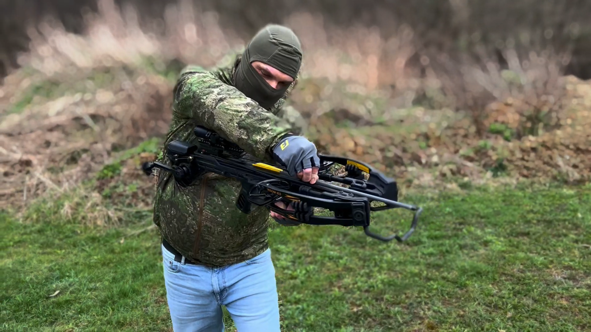 Shooter recocking a traditional single-shot crossbow by hand