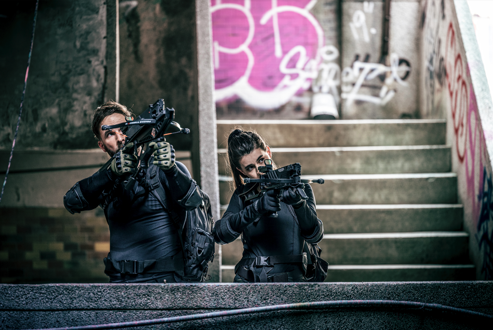 Two shooters aiming repeating crossbows in an urban setting