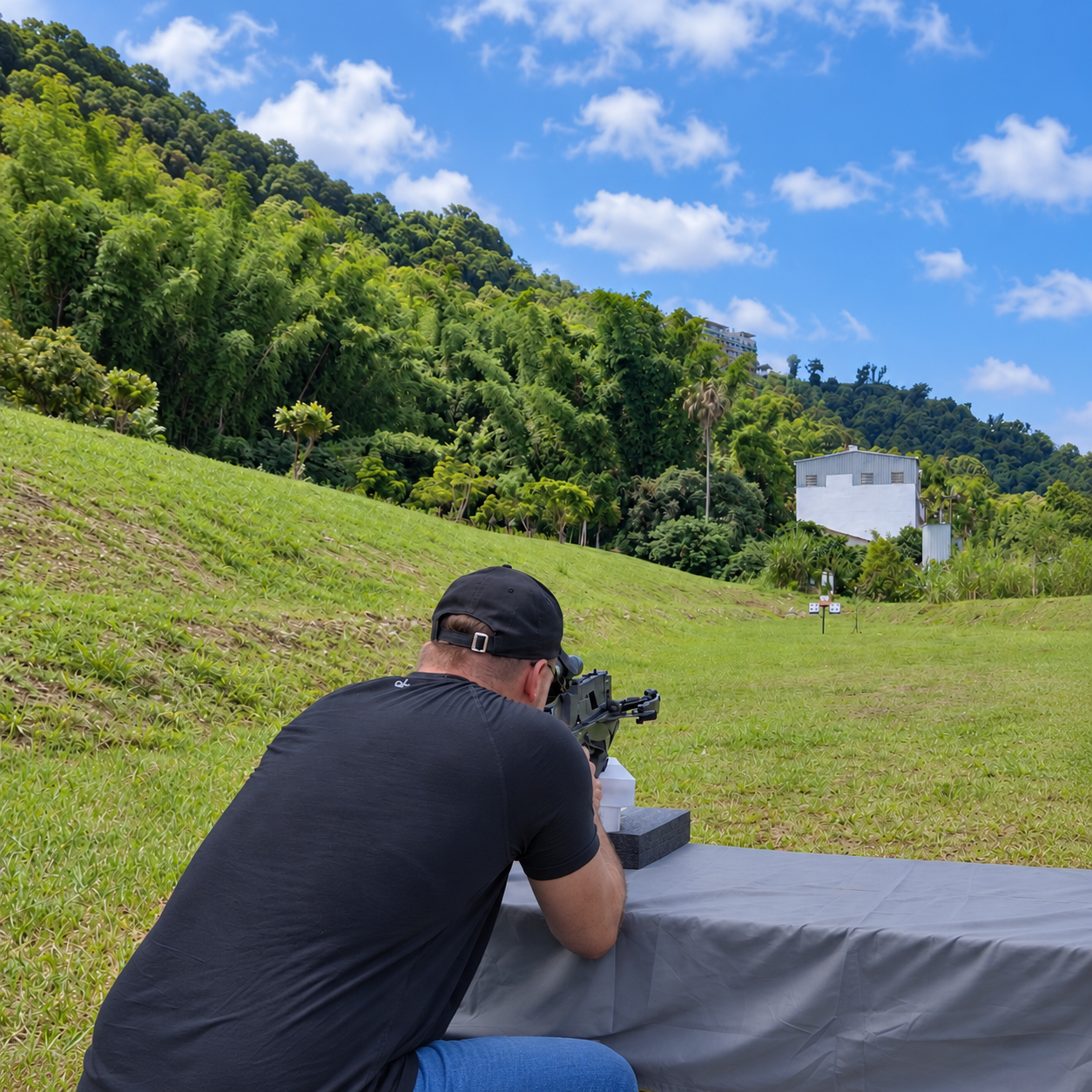 Shooter sighting in a crossbow from a stable rest at an outdoor range